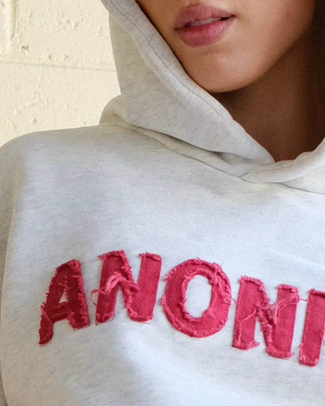 Woman wearing Societa Anonima hoodie in marle grey