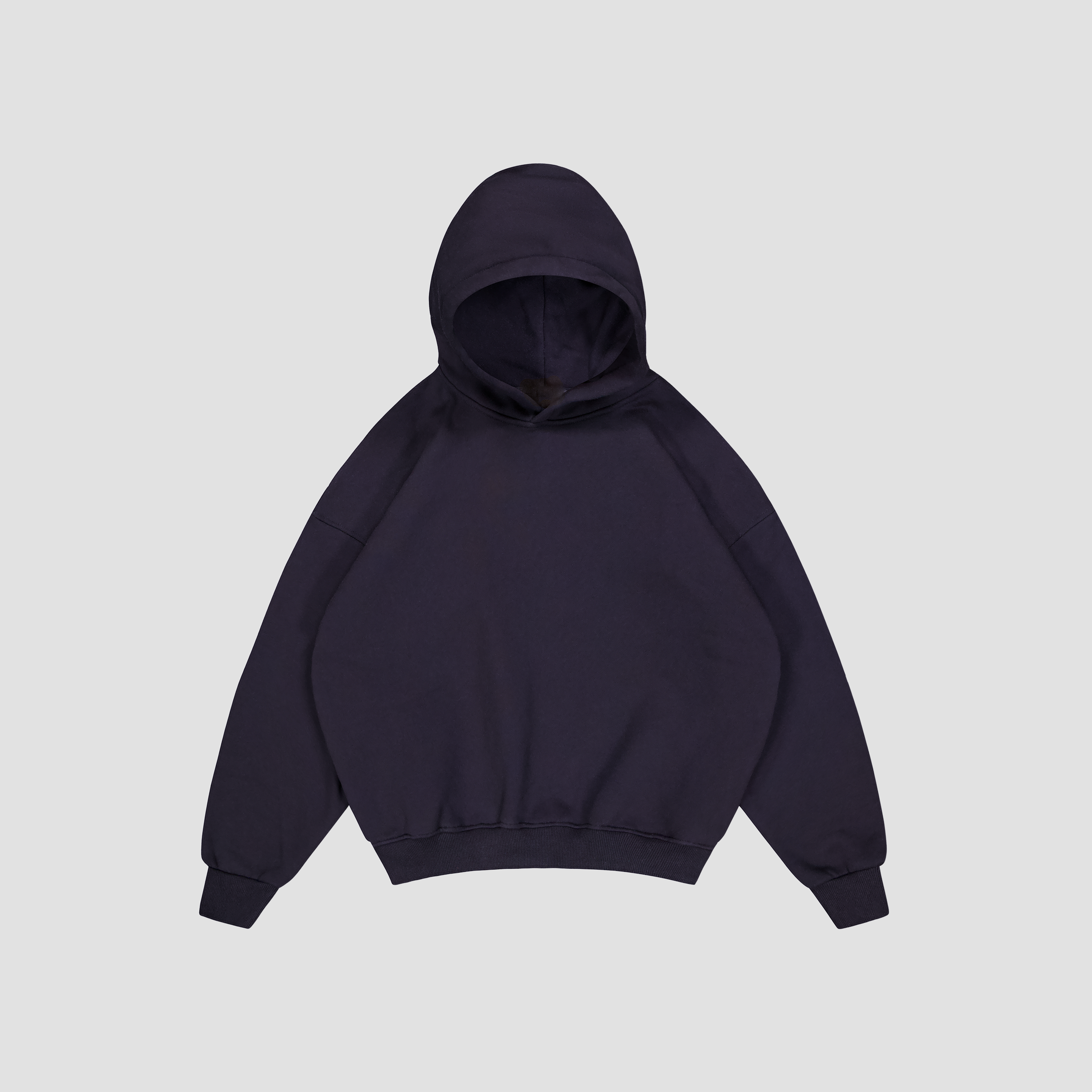 Flat lay of Midnight Blue hoodie on a light gray background